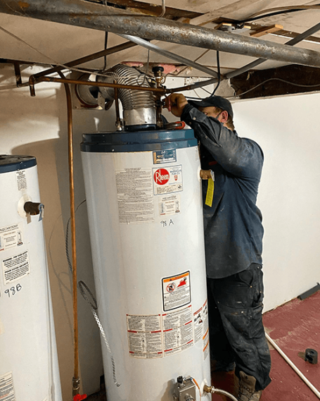 plumber working on hot water tank